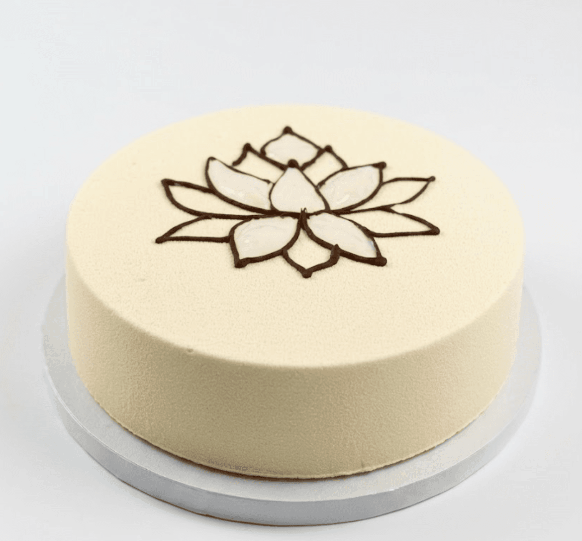 White bento cake with chocolate lotus design — elegant dessert